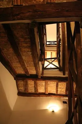 an overhead view of a wooden ceiling with a light at Portico d'Ottavia, the ancient Rome in Rome