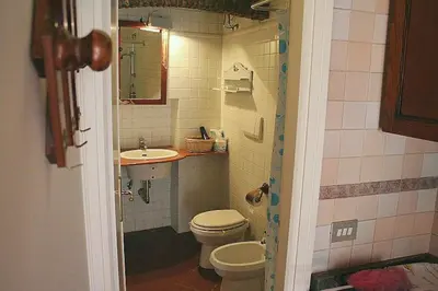 a bathroom with a toilet and a sink at Portico d'Ottavia, the ancient Rome in Rome
