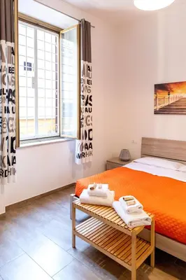 a bedroom with a bed and a window at Sannio Apartment - near Metro San Giovanni by RHR in Rome