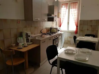 a small kitchen with a table and chairs and a table and a tableablish at APPARTAMENTO SIMONE DUE in Rome