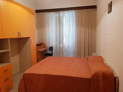 a bedroom with a bed and a dresser and a window at APPARTAMENTO SIMONE DUE in Rome