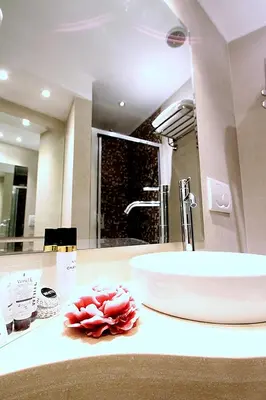 a bathroom counter with a sink and a mirror at Locanda Navona in Rome