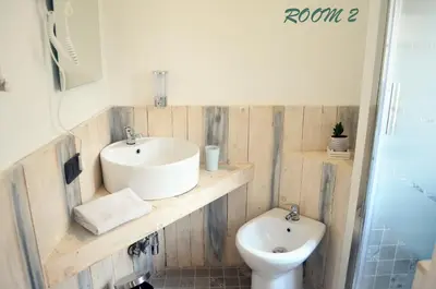 a bathroom with a sink and a toilet at Gianicolo Country Room in Rome