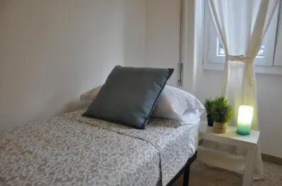 a bedroom with a bed with a pillow and a candle at RELAX INN VATICAN in Rome