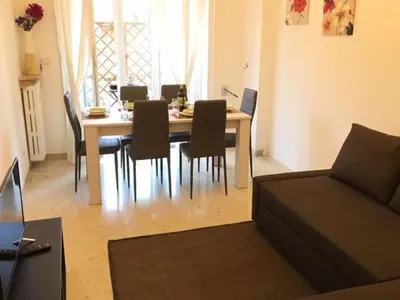 a dining room table and chairs in a living room at RELAX INN VATICAN in Rome