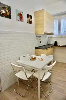 a white table and chairs in a kitchen at Home Vatican Star in Rome
