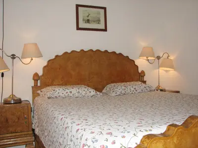 a bedroom with a large bed and two lamps at Centro Storico - Piazza di Spagna in Rome