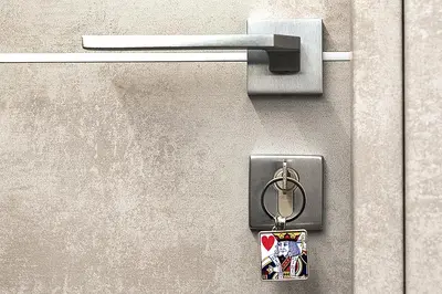 a metal doorhandle with a keychain attached to it at My Love Suite in Rome