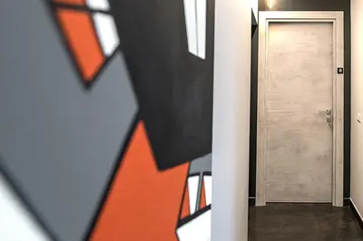 a hallway with a door and an orange painting on the wall at My Love Suite in Rome