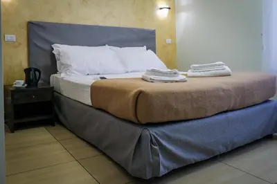 a bed with towels on top of it in a room at Mocenigo Vatican Suites in Rome
