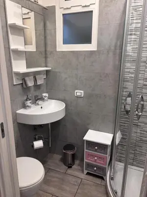 a small bathroom with a sink and a shower at Pietro's house in Rome