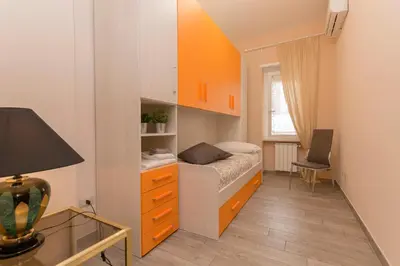 a small bedroom with a bed and a desk at Il Giardino degli Agrumi - Roma in Rome