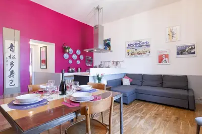a living room with a table and a couch at Rome As You Feel - Vittorio Colorful Design Apartment in Rome
