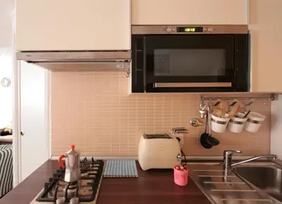 a kitchen with a sink and a microwave at Roma center Fori Imperiali Raffy's charming Suite in Rome