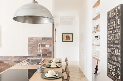 a kitchen with a table with chairs and a sink at THE BREAK - Via Veneto Charming Suite in Rome