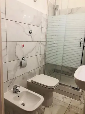 a bathroom with a toilet and a shower and a sink at COMFORT INN ROMA TERMINI in Rome
