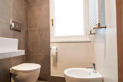 a bathroom with a toilet and a sink at GuestHost - Vatican Museums Cozy Flat x4 in Rome