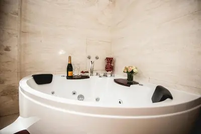 a bath tub with a bottle of champagne in a bathroom at PRATI 1930 Boutique apartments Rome in Rome