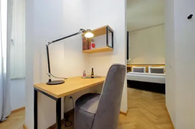 a desk with a chair and a lamp and a bed at Youroom Abruzzi in Rome