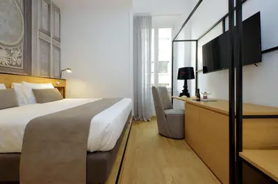 a hotel room with a bed and a desk at Youroom Abruzzi in Rome