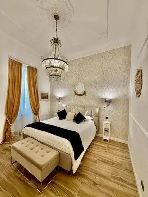 a bedroom with a bed and a painting on the wall at Colosseo Room in Rome