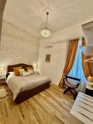 a living room with a couch and a painting on the wall at Colosseo Room in Rome
