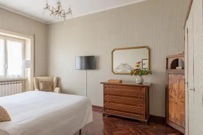 a bedroom with a bed and a dresser and a mirror at Vatican Cozy Apartment with Terrace in Rome