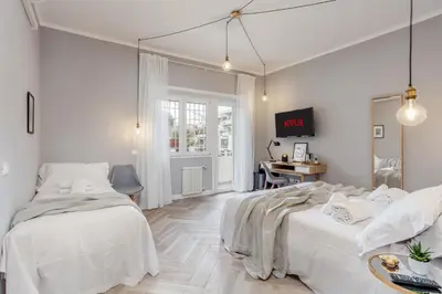 a white bedroom with a bed and a desk at Otium Fornaci San Pietro Vaticano Castel Sant'Angelo in Rome