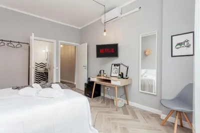 a white bedroom with a bed and a desk at Otium Fornaci San Pietro Vaticano Castel Sant'Angelo in Rome