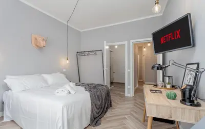 a bedroom with a white bed and a tv on the wall at Otium Fornaci San Pietro Vaticano Castel Sant'Angelo in Rome