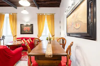 a living room with a table and a red couch at Sistina House Style HolidayHome x 6 in Rome