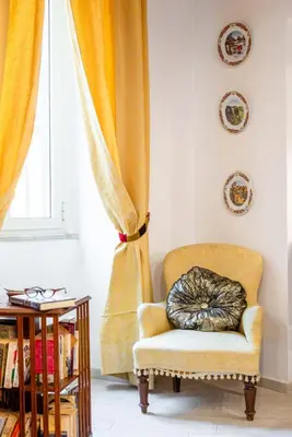 a cat sleeping on a chair in front of a window at Sistina House Style HolidayHome x 6 in Rome