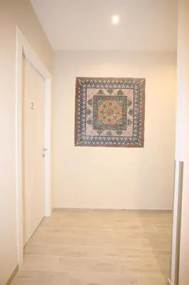 a room with a rug on the wall and a painting on the wall at Unique luxury apartment and rooms in Rome