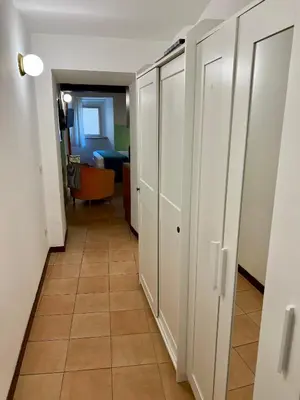 a hallway with white cabinets and a tile floor at Charming Campo de' Fiori in Rome