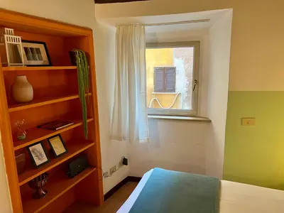 a bedroom with a bed and a window at Charming Campo de' Fiori in Rome