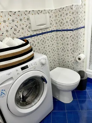 a bathroom with a washing machine and a toilet at Charming Campo de' Fiori in Rome