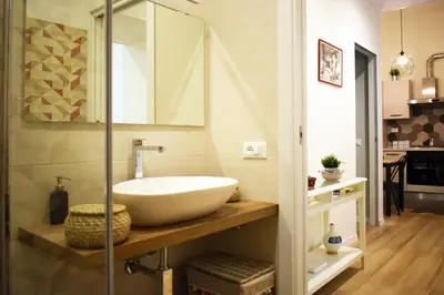 a bathroom with a bowl sink on a counter at Rome Labicana Apartment in Rome
