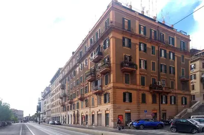 a large brick building on the side of a street at Rome Labicana Apartment in Rome