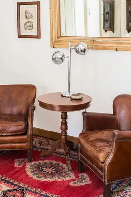 a room with two chairs and a table with a lamp at R.C. Cappellari Charming Campo de Fiori in Rome