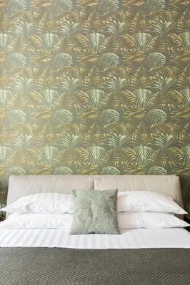 a bedroom with a wall with a floral wallpaper at Horti Sallustiani Roma in Rome