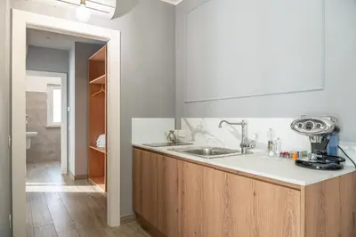 a kitchen with a sink and a counter top at Nouvelle Maison Rome Luxury Palace in Rome