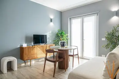 a living room with a table and a tv at Nouvelle Maison Rome Luxury Palace in Rome