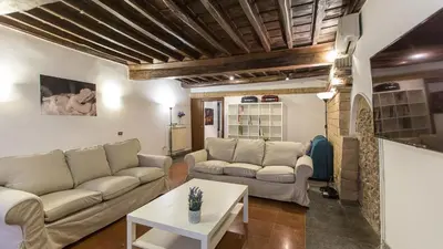 a living room with two couches and a table at Rental in Rome Scala Deluxe in Rome