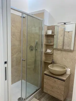 a bathroom with a glass shower and a sink at Zeus Inn - Una finestra sul Vaticano in Rome