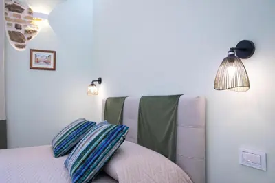 a bedroom with a bed with two pillows on it at Zeus Inn - Una finestra sul Vaticano in Rome