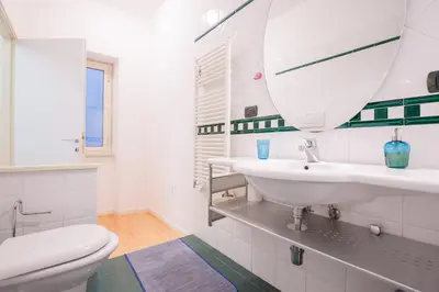 a white bathroom with a sink and a toilet at Dream House Vaticano in Rome