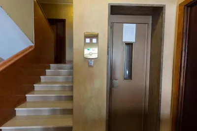 a hallway with a staircase with a door and a stairwell at Rizzo St. Peter apartment in Rome