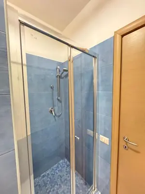 a shower with a glass door in a bathroom at Rizzo St. Peter apartment in Rome