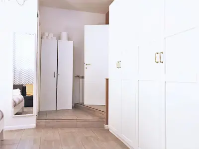 a room with white cabinets and a mirror at CRIS - close to VATICAN - Centre&StadiumArea in Rome