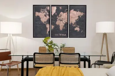 a dining room with four tables and a world map on the wall at New! Spanish Step Design Apartment in Rome